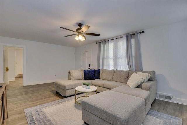 living room featuring hardwood / wood-style flooring and ceiling fan