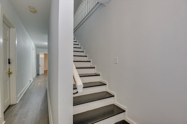 stairway with hardwood / wood-style flooring