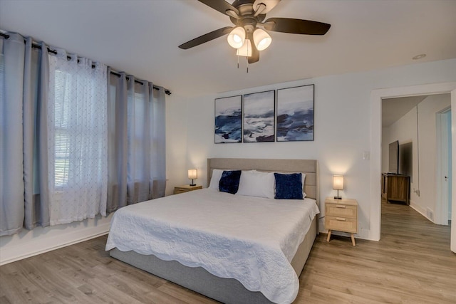 bedroom featuring light hardwood / wood-style floors and ceiling fan