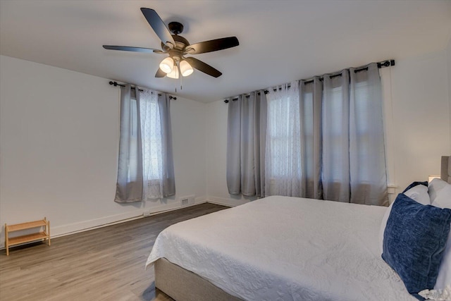 bedroom featuring ceiling fan and hardwood / wood-style floors