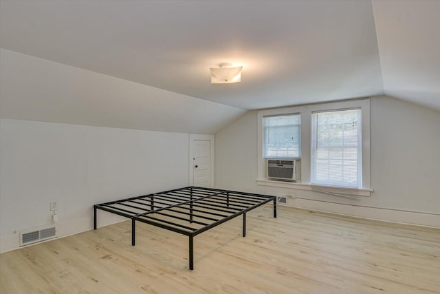 bonus room with light hardwood / wood-style flooring, cooling unit, and lofted ceiling