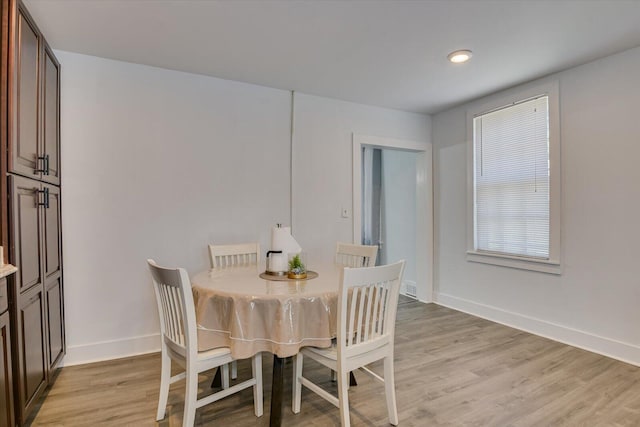 dining area with light hardwood / wood-style flooring