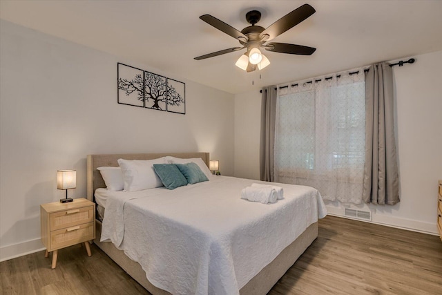 bedroom with ceiling fan and hardwood / wood-style flooring