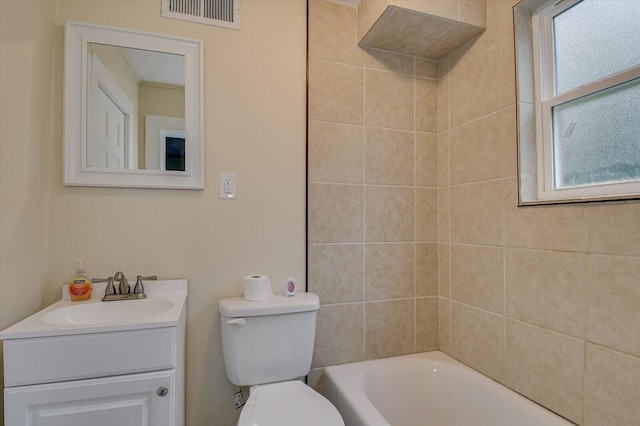 full bathroom with vanity, toilet, plenty of natural light, and tiled shower / bath combo