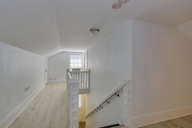 additional living space featuring light hardwood / wood-style flooring and lofted ceiling