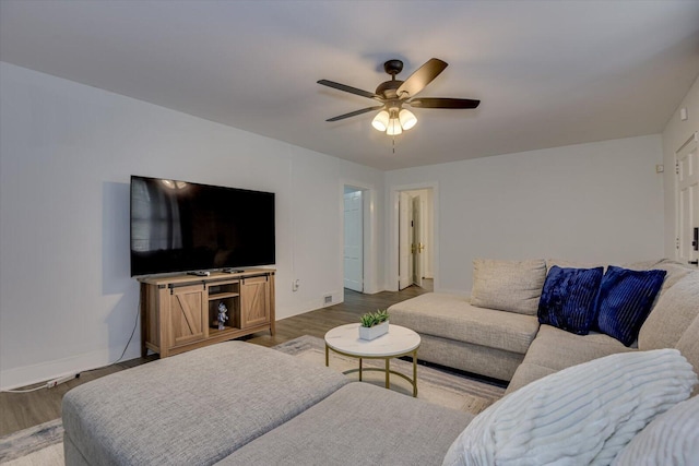 living room featuring dark hardwood / wood-style floors and ceiling fan