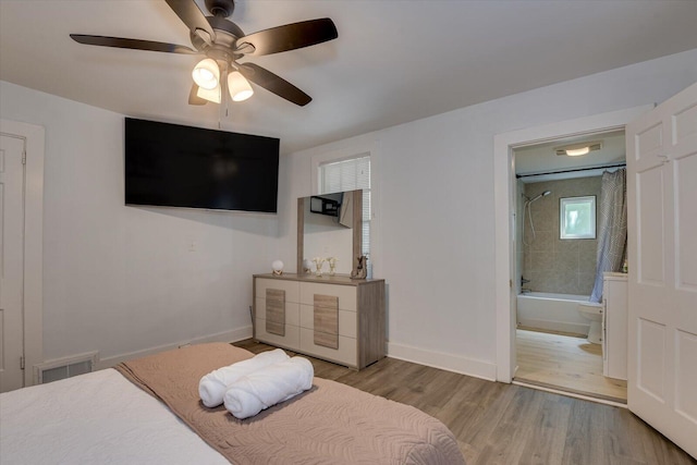 bedroom with ceiling fan, ensuite bathroom, and light hardwood / wood-style floors