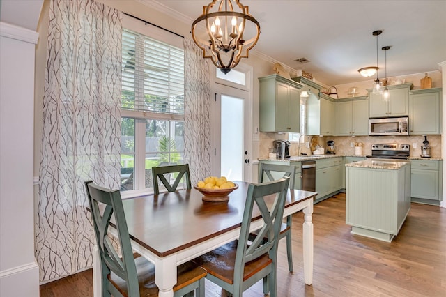 714 Neville St, Grovetown, GA 30813 - dining space with a chandelier, crown molding, and wood finished floors