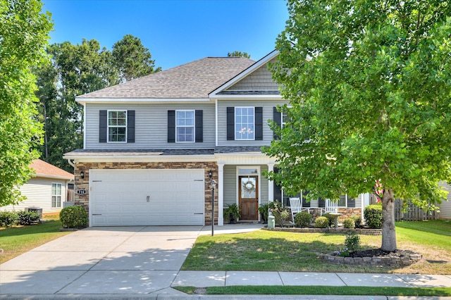 714 Neville St, Grovetown, GA 30813 - view of front facade featuring driveway, a front lawn, stone siding, and a garage