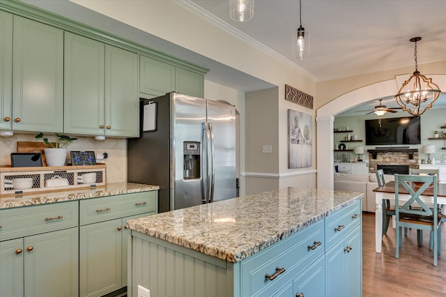 714 Neville St, Grovetown, GA 30813 - kitchen featuring stainless steel fridge, green cabinets, arched walkways, tasteful backsplash, and crown molding