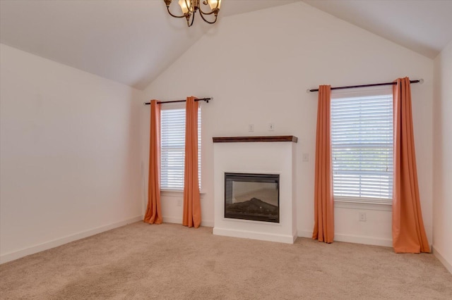 unfurnished living room with carpet floors, lofted ceiling, and a glass covered fireplace