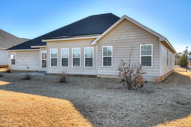 back of property featuring roof with shingles