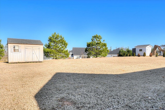 view of yard with a storage unit and an outbuilding