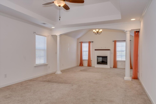 unfurnished living room featuring visible vents, a tray ceiling, and decorative columns