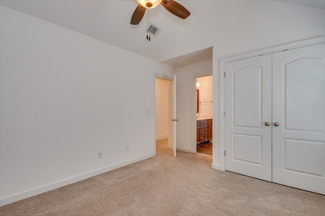 unfurnished bedroom with visible vents, baseboards, ceiling fan, light colored carpet, and a closet