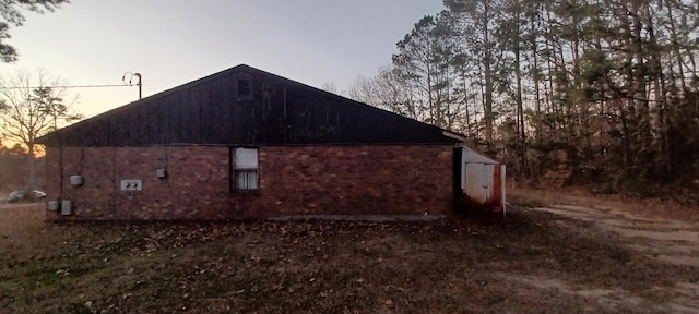 property exterior at dusk with an outbuilding