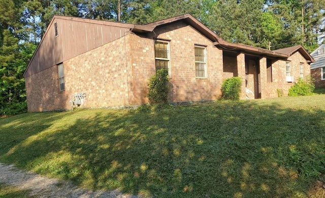 view of side of home featuring a yard