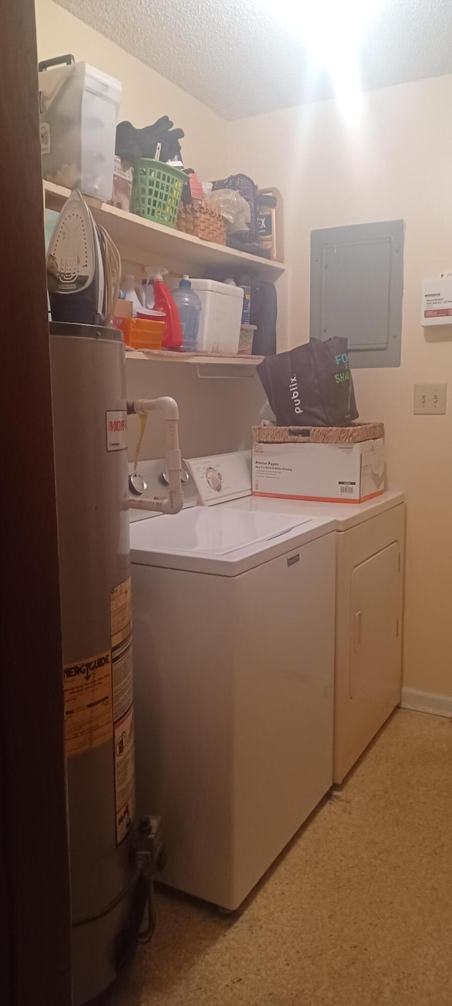 laundry room with electric panel, water heater, washer and dryer, and a textured ceiling