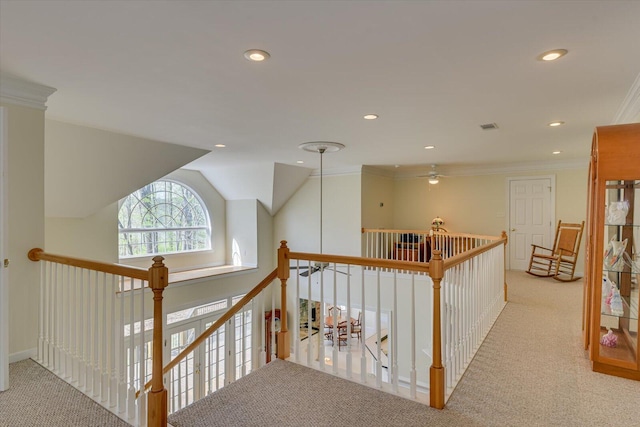 corridor featuring light colored carpet, crown molding, and lofted ceiling