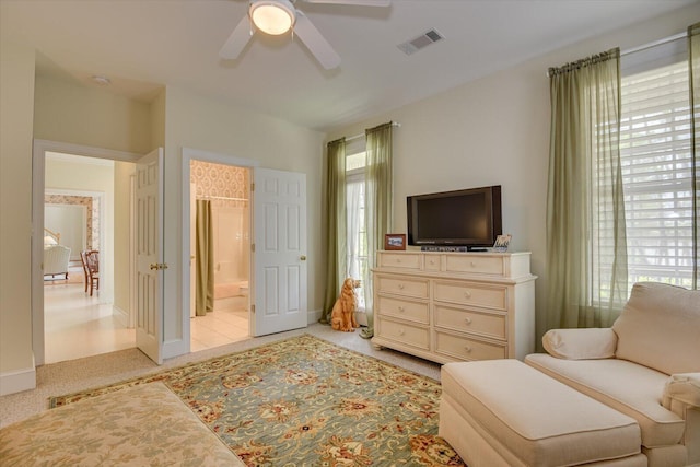 living area featuring light colored carpet and ceiling fan