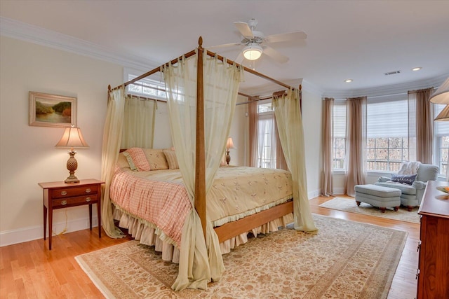 bedroom with hardwood / wood-style flooring, ceiling fan, and ornamental molding