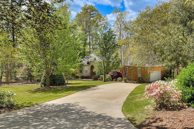 view of front of house with a garage and a front yard