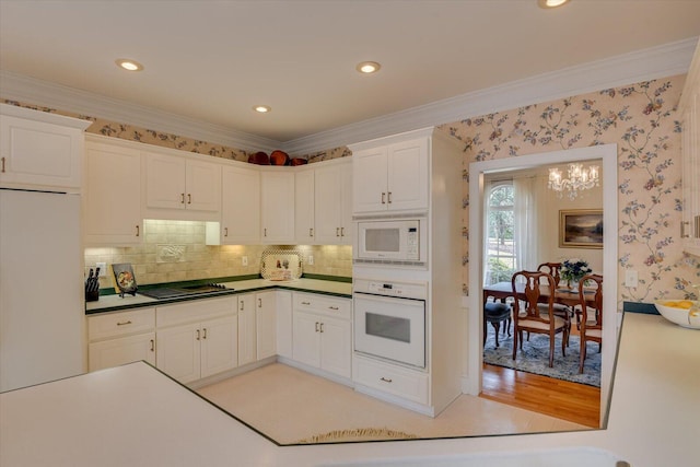 kitchen with white cabinets, white appliances, ornamental molding, and backsplash