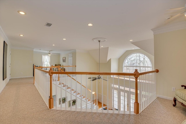 hall with light carpet, vaulted ceiling, and ornamental molding