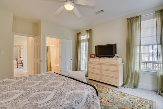 carpeted bedroom with ceiling fan and multiple windows