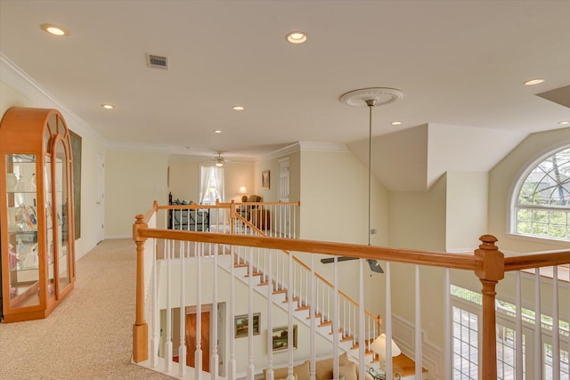 hall featuring light colored carpet, lofted ceiling, and ornamental molding