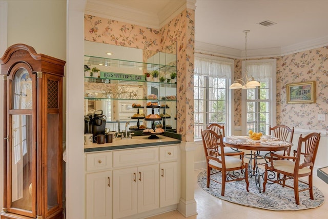 dining room with sink and crown molding