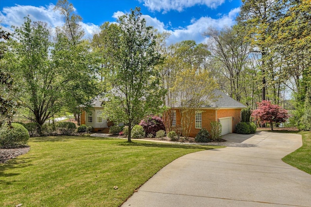 view of front of property featuring a garage and a front lawn