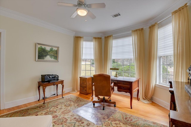 office space with a wealth of natural light, ceiling fan, and light wood-type flooring