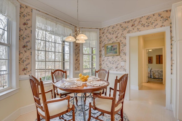 dining area with a healthy amount of sunlight, crown molding, and an inviting chandelier