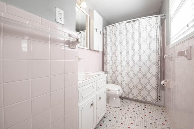 bathroom featuring curtained shower, vanity, and toilet