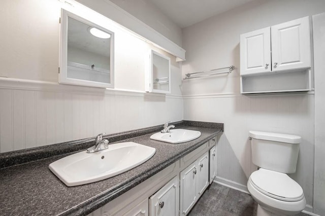 bathroom featuring vanity, wood-type flooring, and toilet