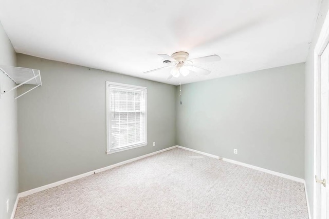 carpeted empty room featuring ceiling fan