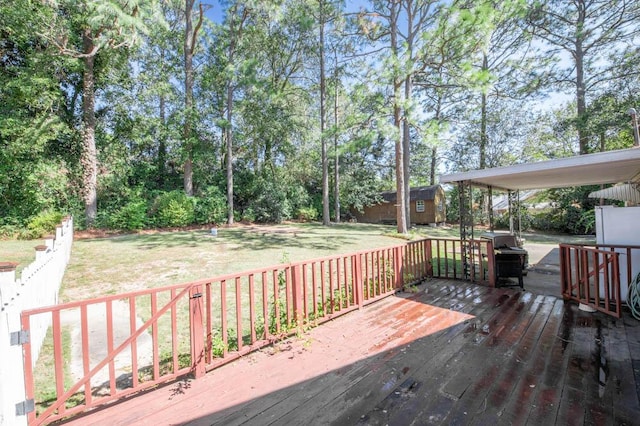 wooden terrace featuring a yard