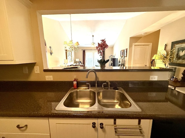 384 Connor Cir, Evans, GA 30809 - kitchen featuring a sink, white cabinets, dark countertops, and a chandelier