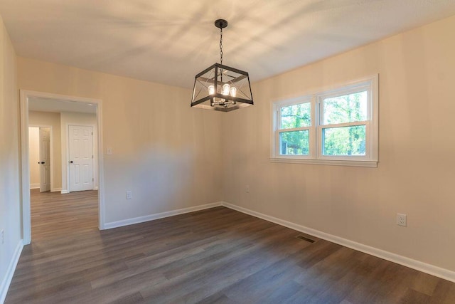2011 Kennedy Dr, Augusta, GA 30904 - spare room featuring a chandelier and dark wood-type flooring