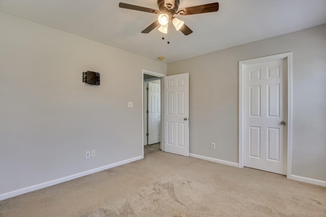 unfurnished bedroom featuring light colored carpet and ceiling fan