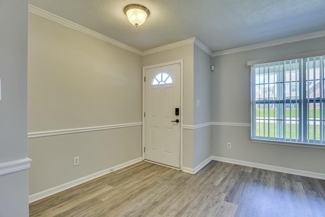 foyer featuring crown molding, plenty of natural light, and hardwood / wood-style flooring