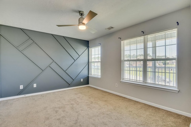 carpeted empty room featuring ceiling fan