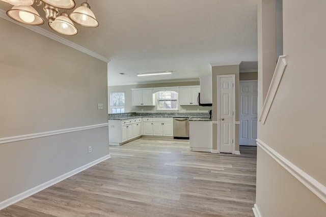 kitchen with an inviting chandelier, stainless steel dishwasher, crown molding, light hardwood / wood-style floors, and white cabinets