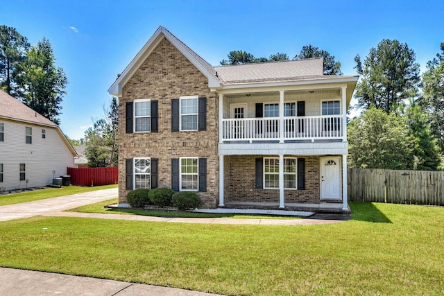 view of front of home featuring a balcony and a front lawn