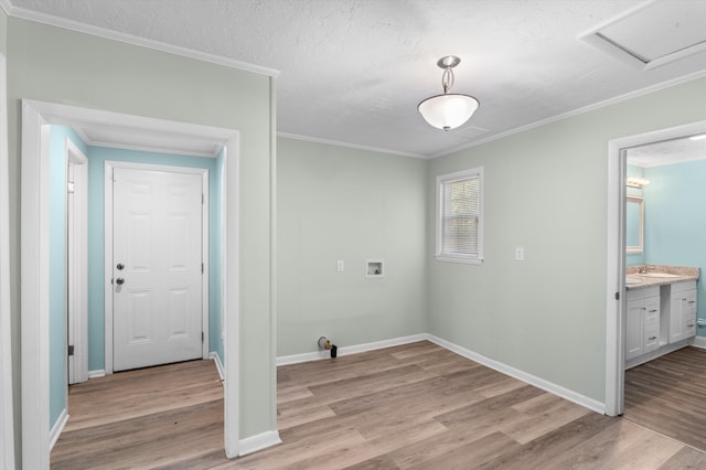 1940 Telfair St, Augusta, GA 30904 - laundry room with light wood-style floors, crown molding, hookup for a washing machine, baseboards, and a textured ceiling
