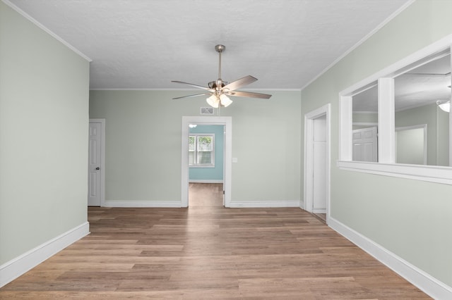 1940 Telfair St, Augusta, GA 30904 - spare room featuring ceiling fan, crown molding, wood finished floors, baseboards, and a textured ceiling