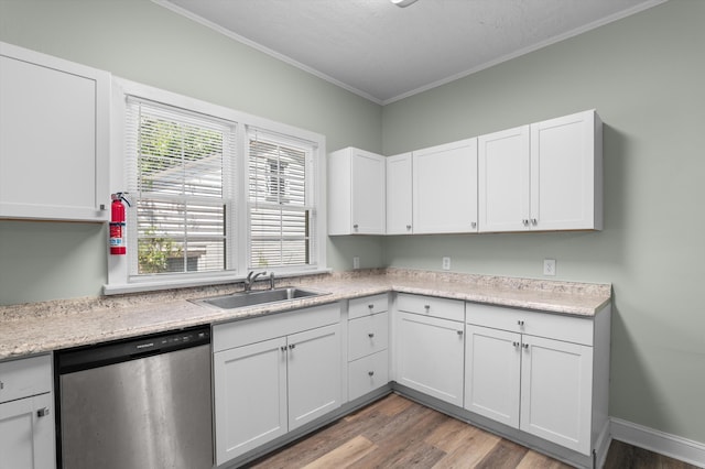 1940 Telfair St, Augusta, GA 30904 - kitchen featuring stainless steel dishwasher, a sink, light wood-style flooring, crown molding, and white cabinetry