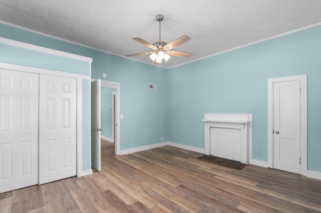 1940 Telfair St, Augusta, GA 30904 - unfurnished bedroom with ornamental molding, wood finished floors, baseboards, ceiling fan, and a closet