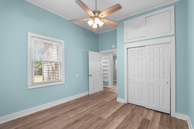 1940 Telfair St, Augusta, GA 30904 - unfurnished bedroom with crown molding, light wood-type flooring, baseboards, a closet, and ceiling fan